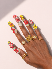 Solar Blossom long square press-on nails worn on hand