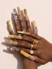 Honeyed Orbit long square press-on nails worn on hand