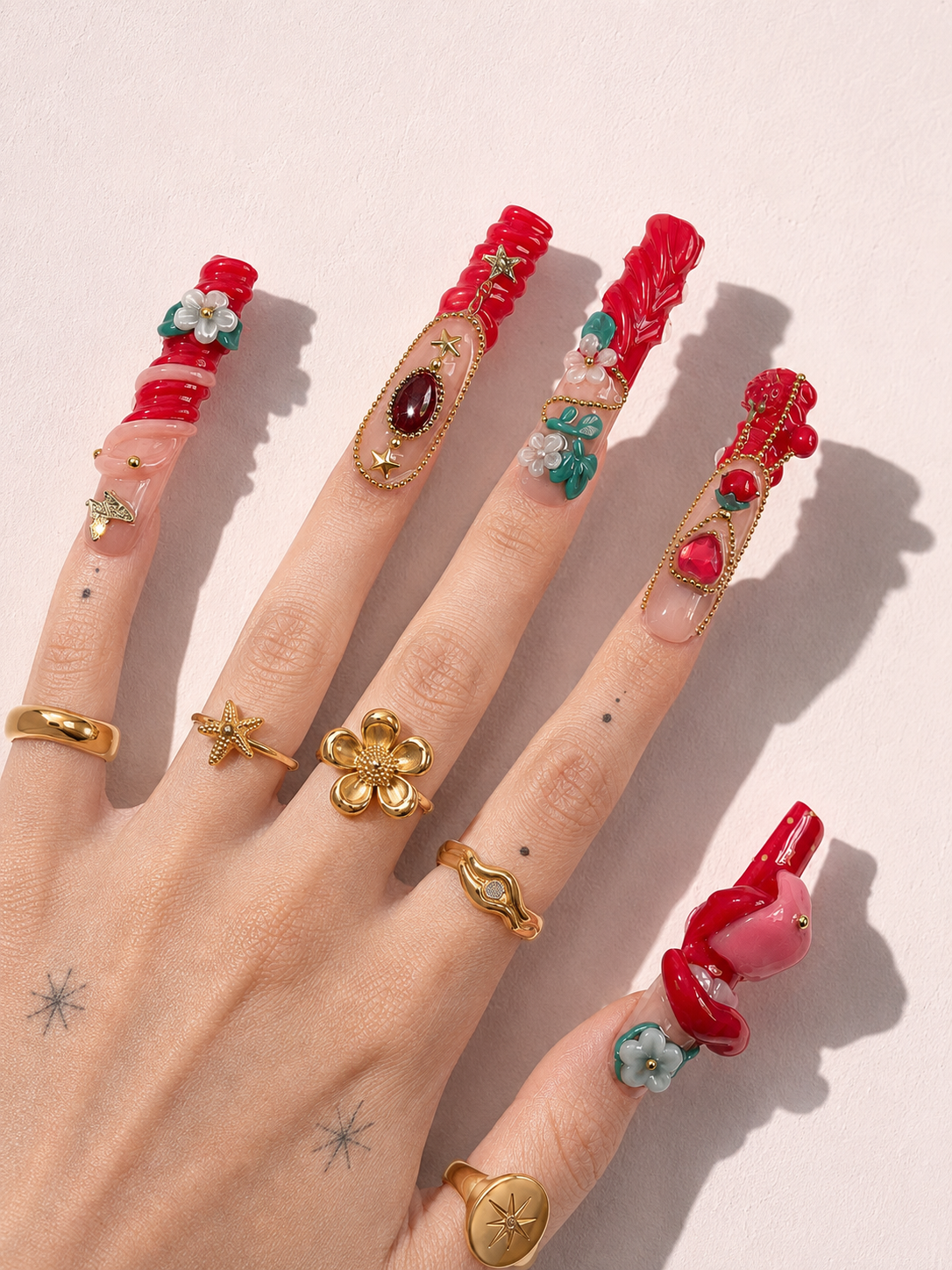 Ruby Tongue long square press-on nails worn on hand