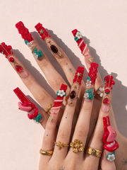 Ruby Tongue long square press-on nails worn on hand