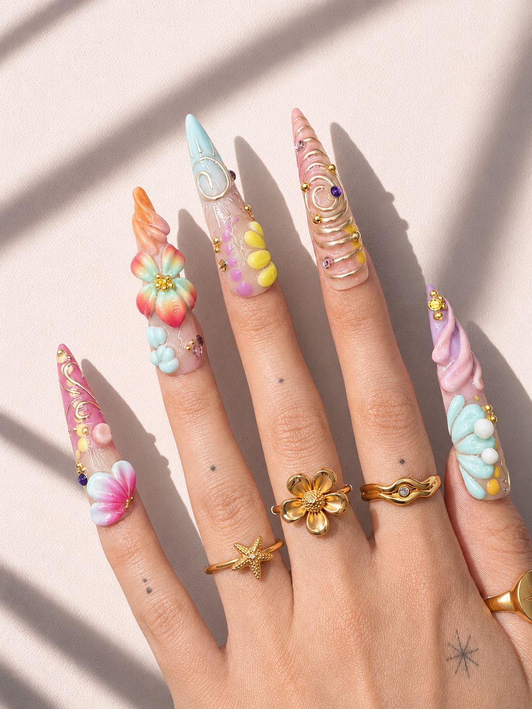 Pastel Current stiletto press-on nails worn on hand