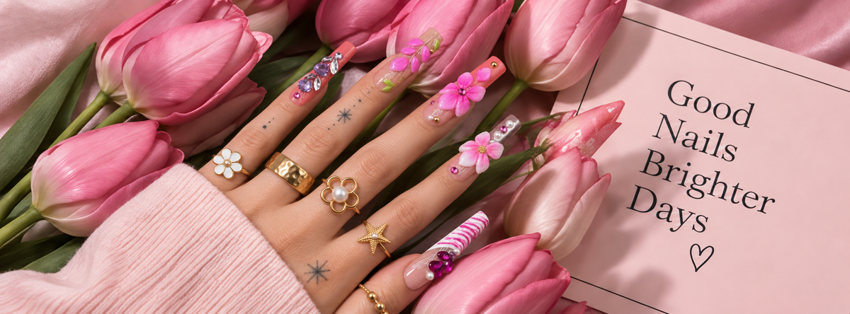 Hand wearing dimensional pink LAVIQO nails and gold rings