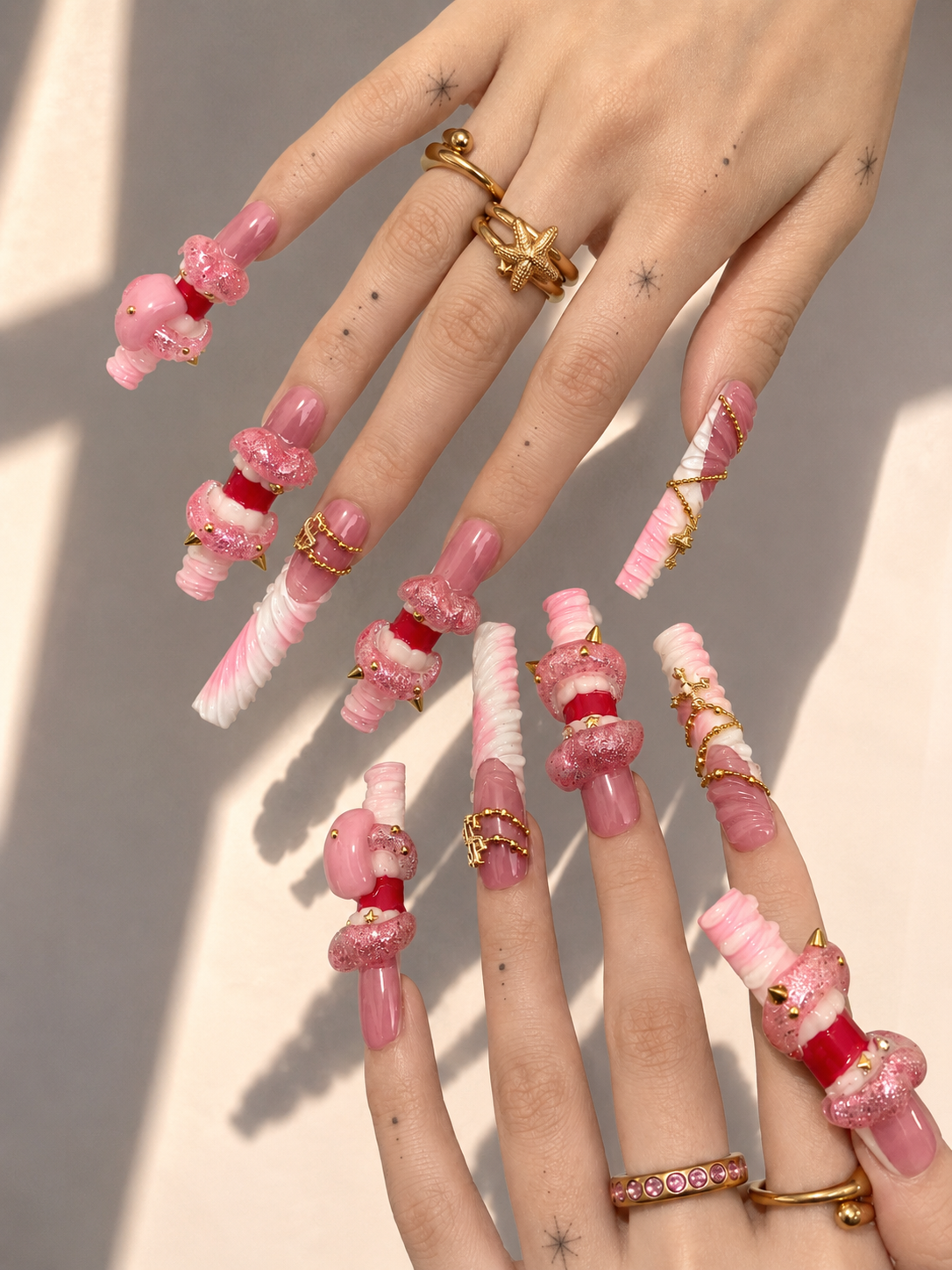 Pink Fang long square press-on nails worn on hand