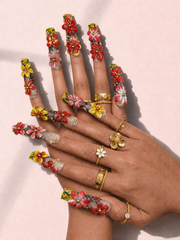 Solar Blossom long square press-on nails worn on hand