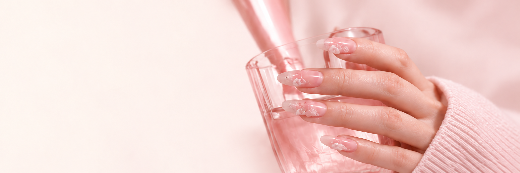 Hand wearing pink floral press-on nails